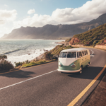Van aménagé pour un road trip avec une route panoramique en arrière-plan